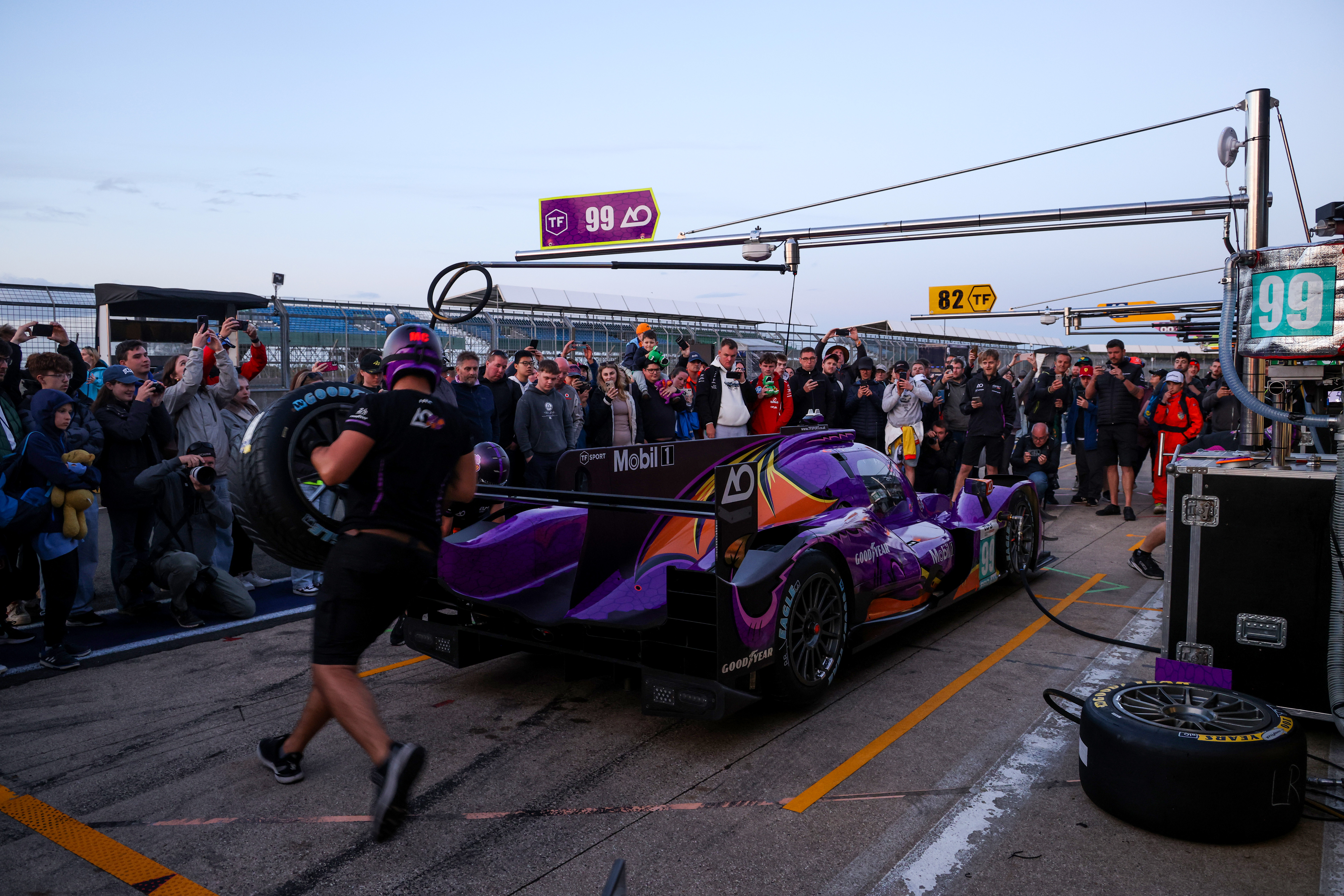 Spectators and team members during a pit walk event at Silverstone Circuit.