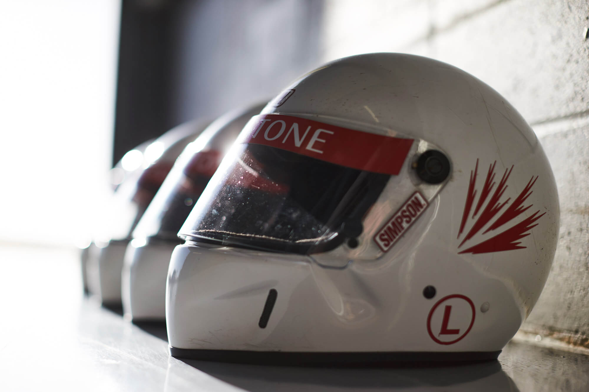 Silverstone branded helmets lined up in a race garage