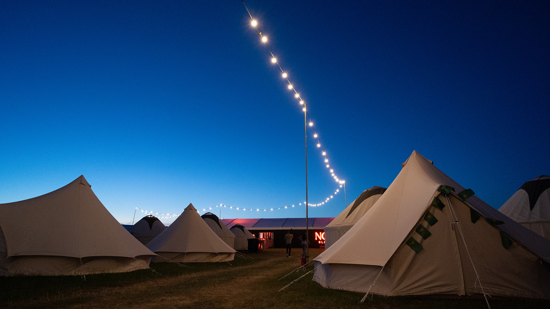 NOVA Glamping tents at dusk