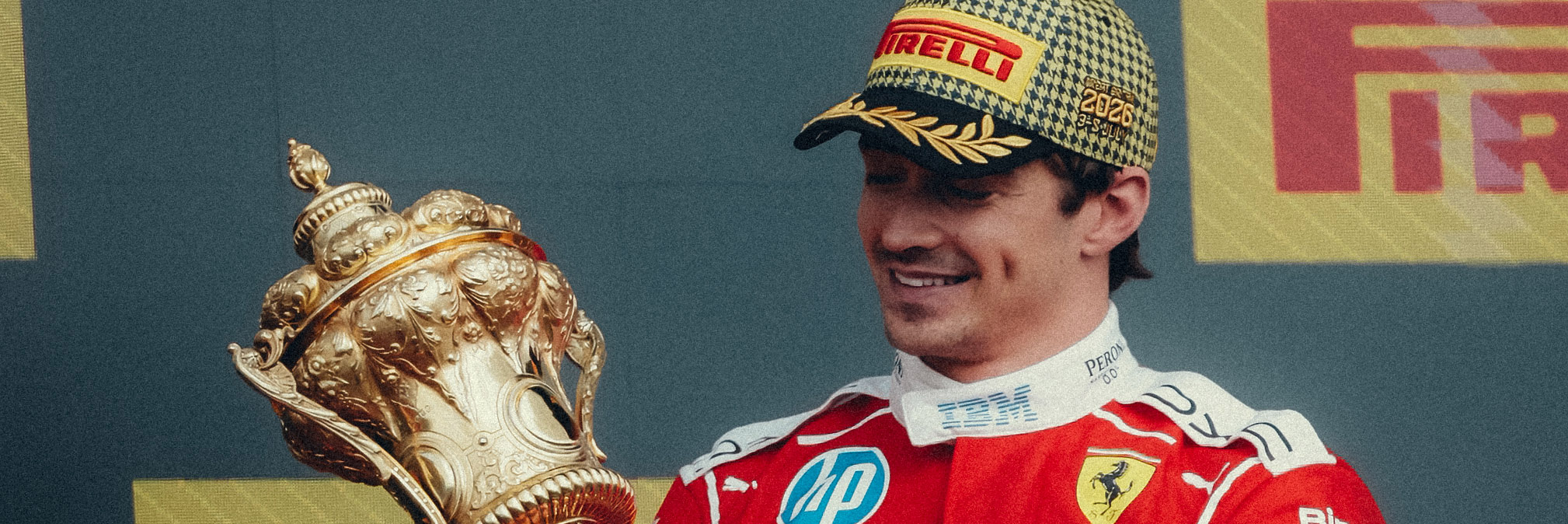 Charles Leclerc looking at the Silverstone trophy
