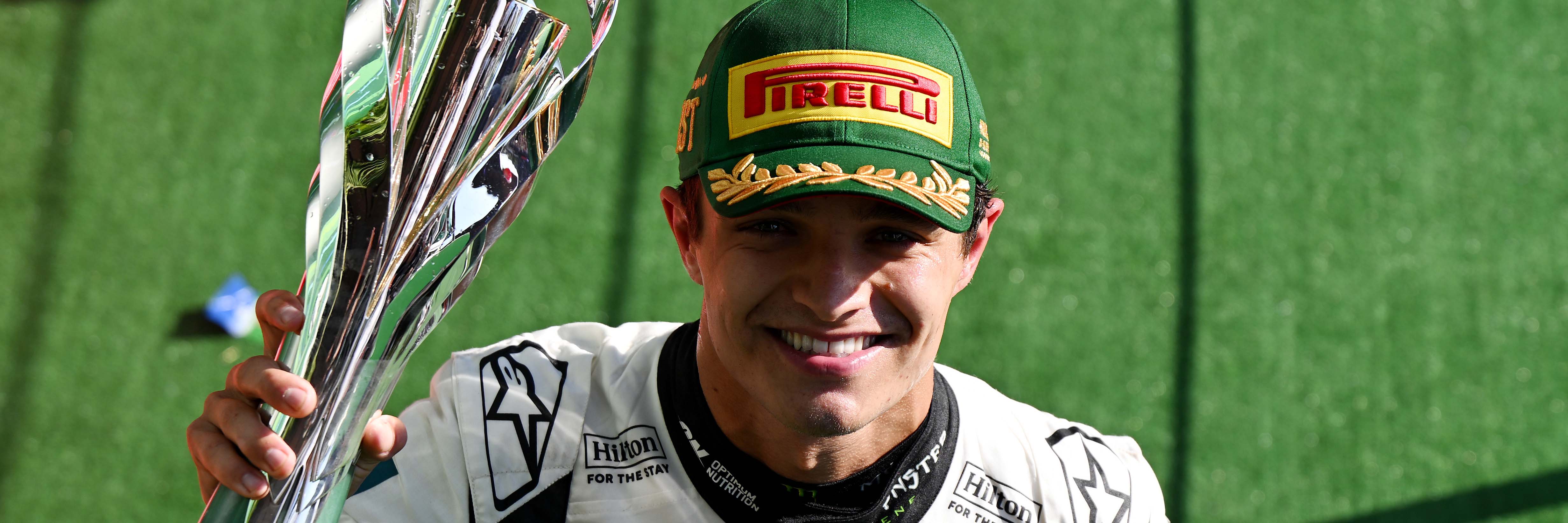 Lando Norris on the podium with his trophy after winning the 2025 Mexico Grand Prix and taking the lead of the championship