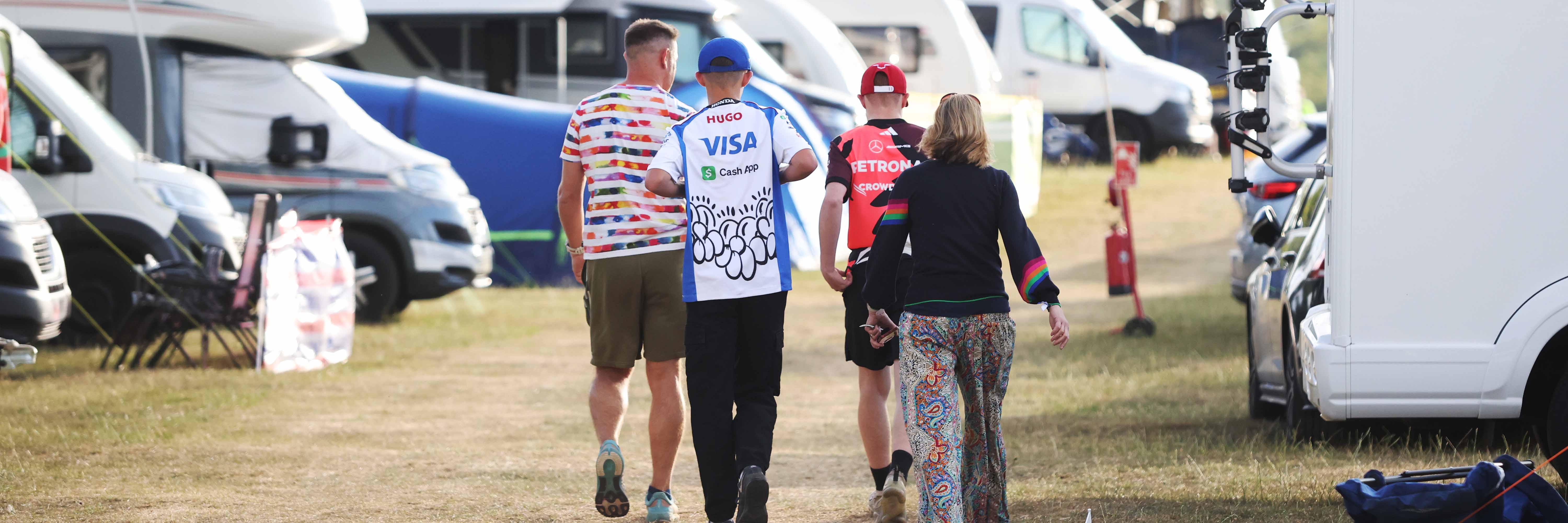 A Racing Bulls fan and a Mercedes F1 fan at a Silverstone campsite