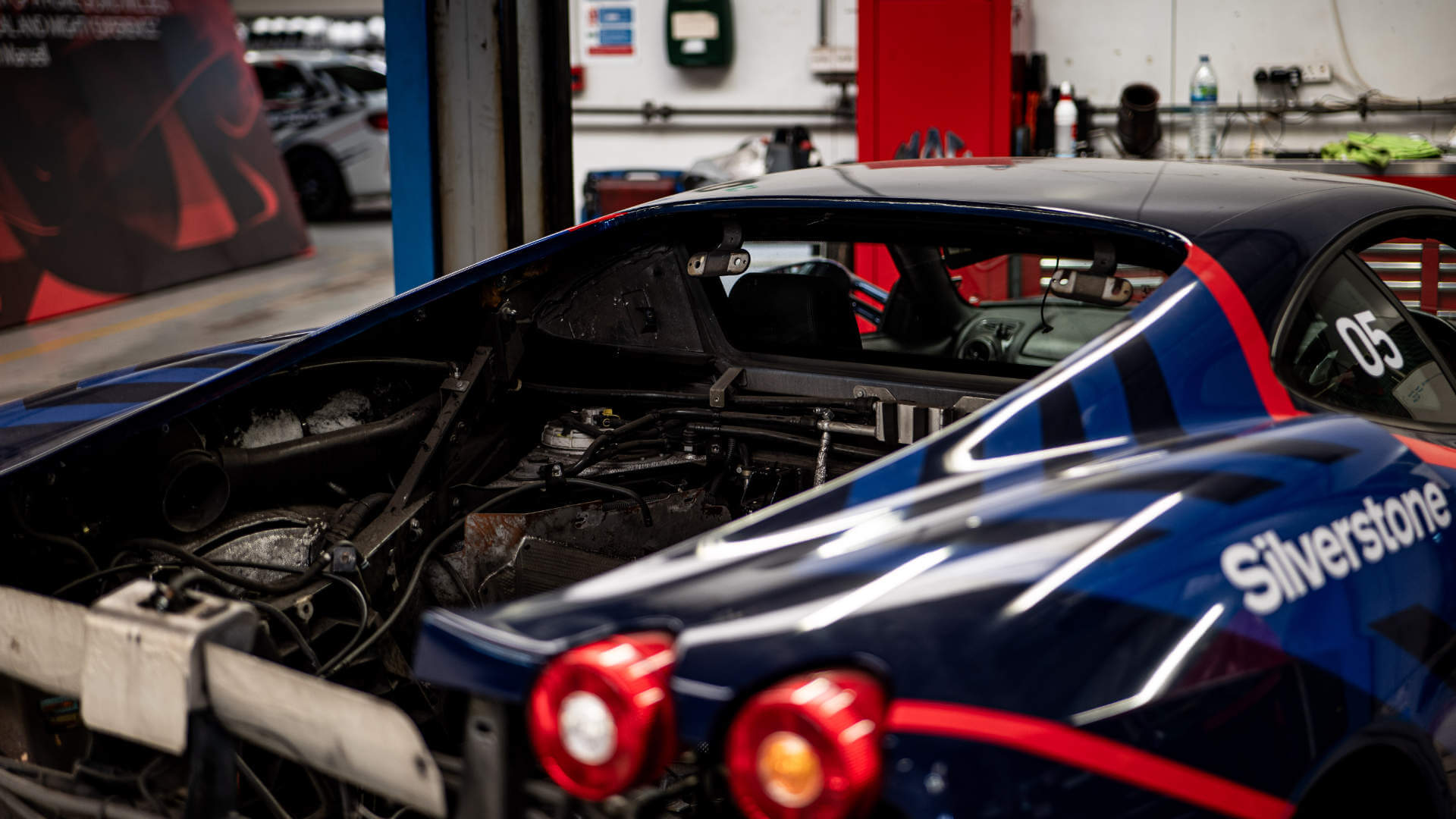 Ferrari F430 with its engine bay open. There is no engine inside. 