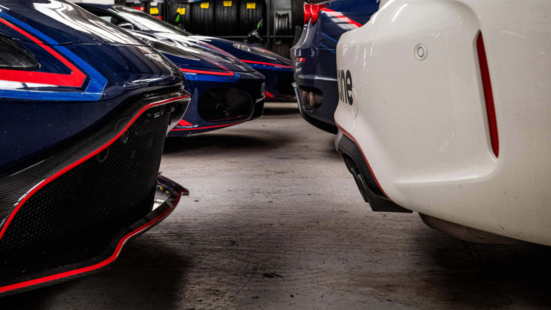 Supercars sit bumper to bumper inside the workshop, showing how many cars can fit inside