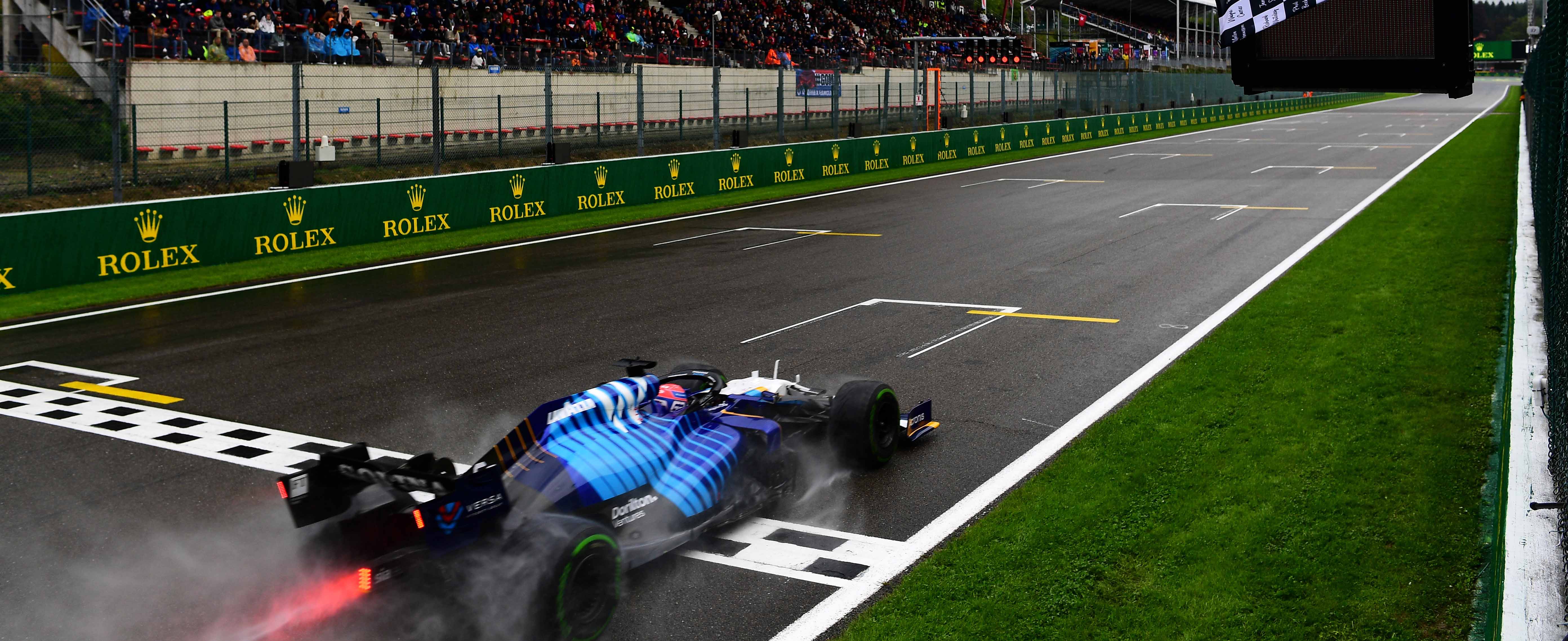 George Russell crossing the line in wet conditions at Spa-Francorchamps