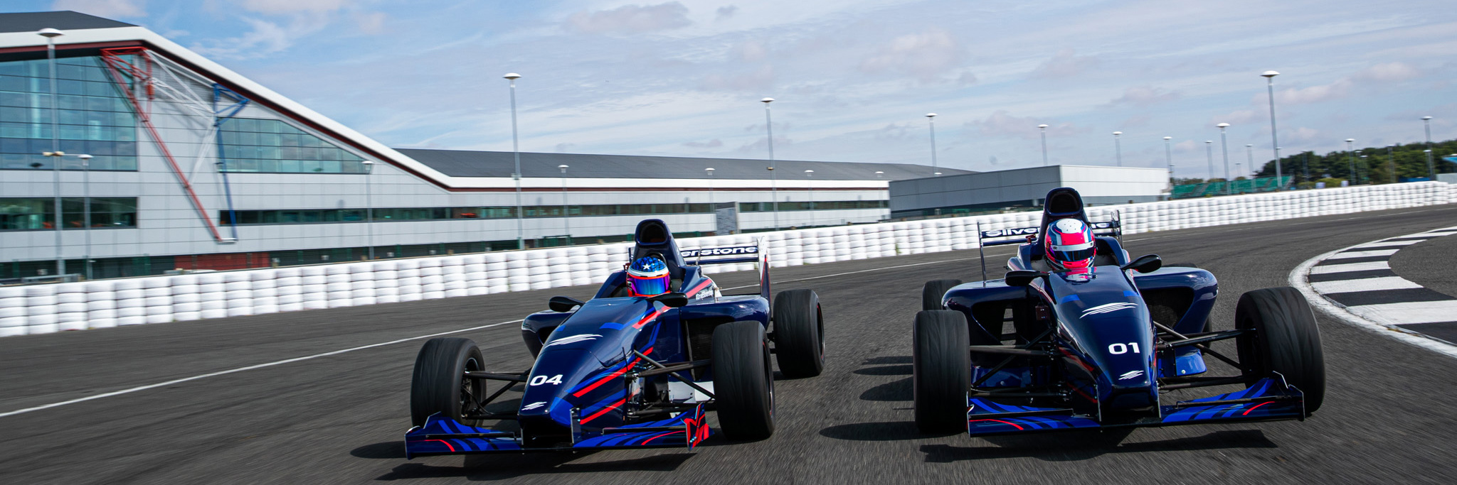Silverstone Formula Singe Seaters racing round a corner during a driving experience