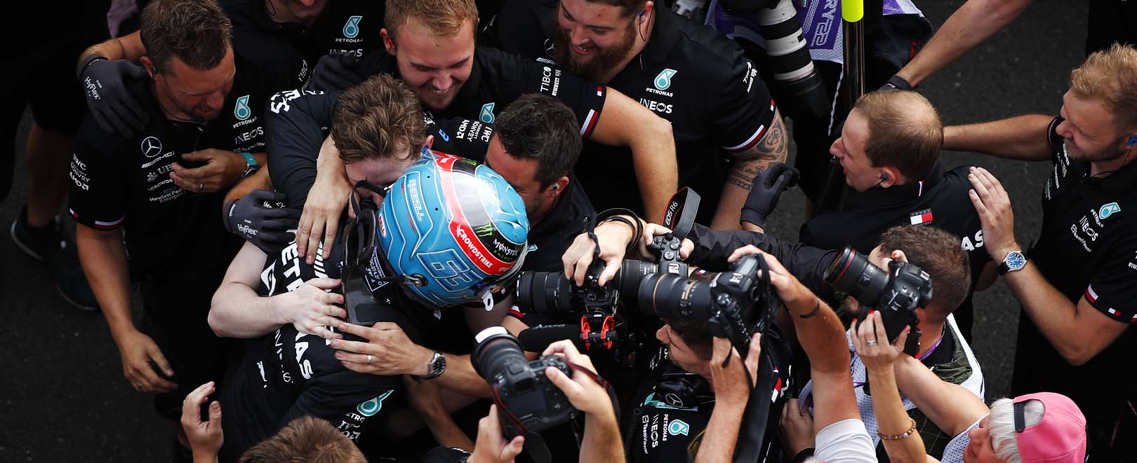 George Russell celebrating with his team after qualifying on pole position at the 2022 Hungarian Grand Prix