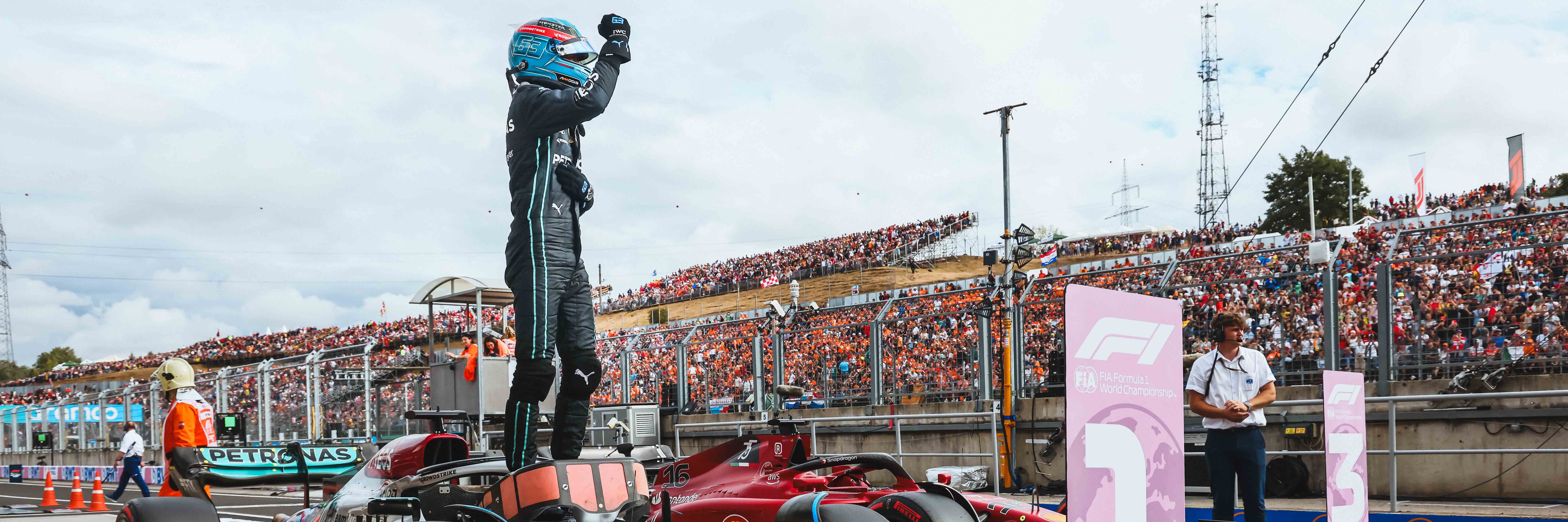 George Russell celebrates taking his maiden pole position at the 2022 Hungarian Grand Prix