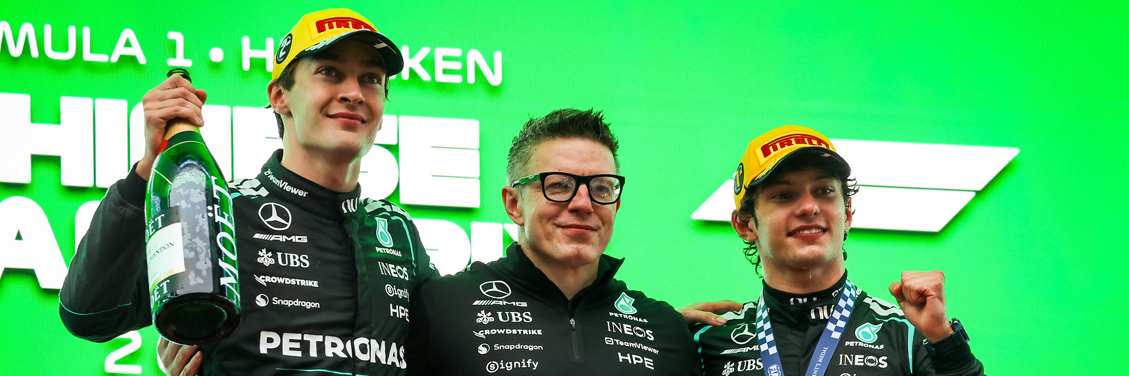 George Russell, Bono and Kimi Antonelli on the Chinese Grand Prix podium