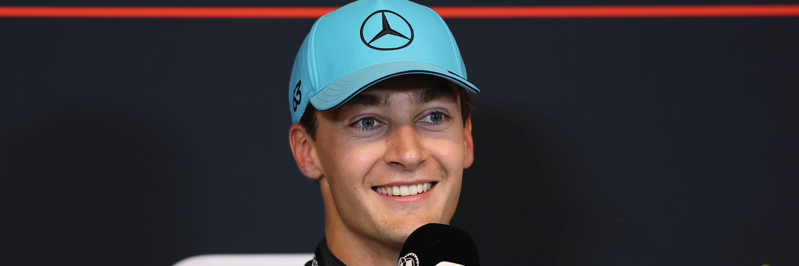 George Russell in a Mercedes F1 hat in the F1 press conference