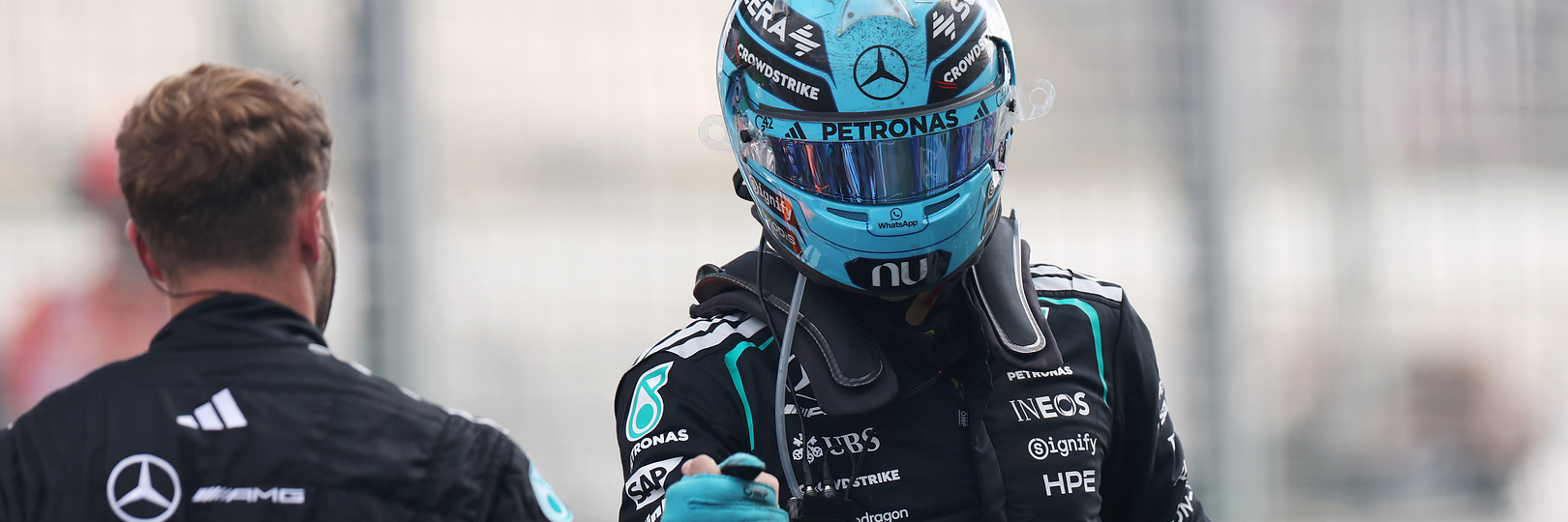 George Russell shaking hands with a MErcedes F1 team member