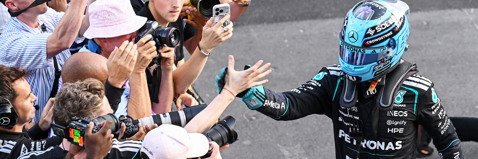 George Russell celebrates with the Mercedes F1 team after winning the Azerbaijan Grand Prix