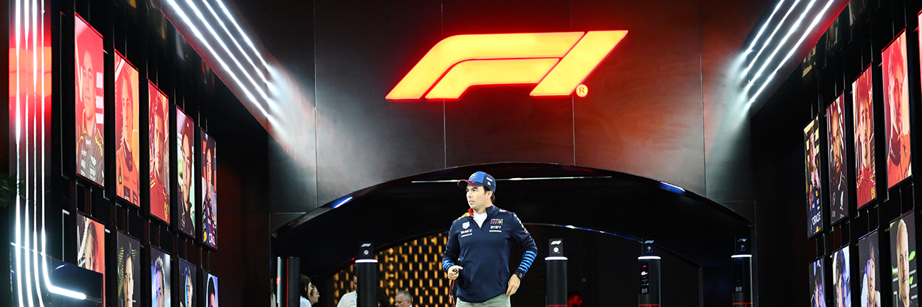 Sergio Perez with the F1 logo above him in the Saudi Arabian Grand Prix paddock