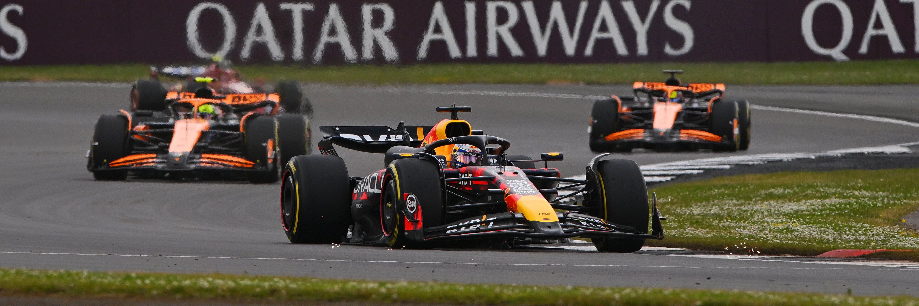 Max Verstappen racing the McLarens at Silverstone