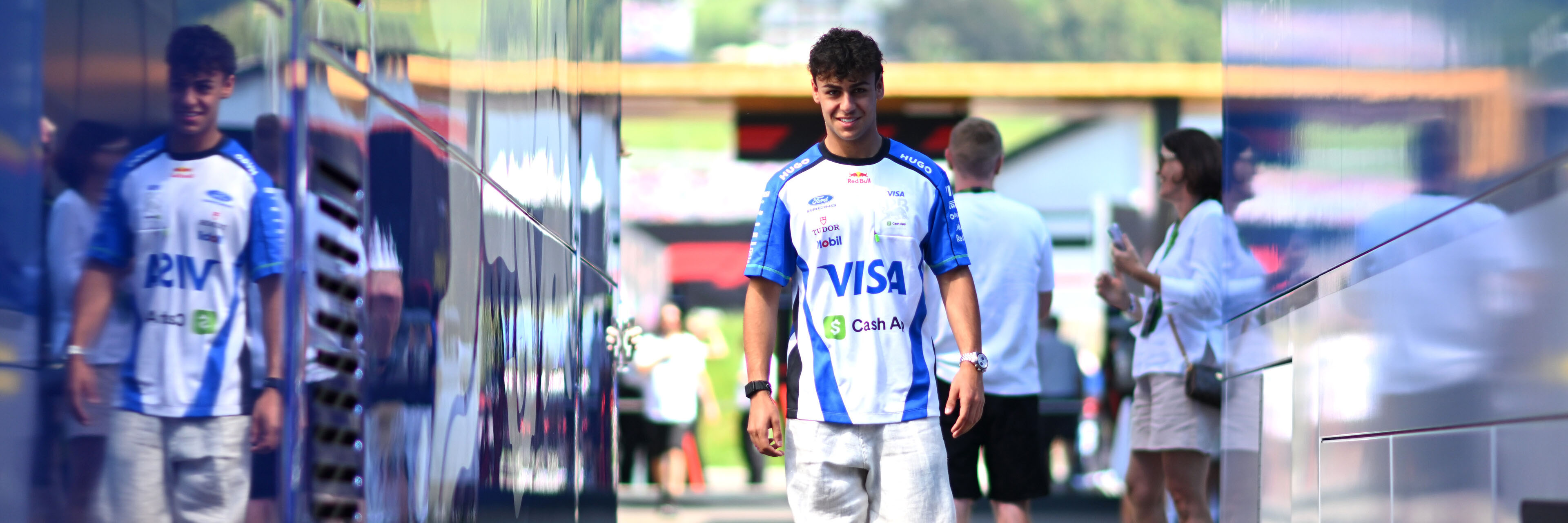 Arvid Lindblad walking through the Red Bull Ring F1 paddock