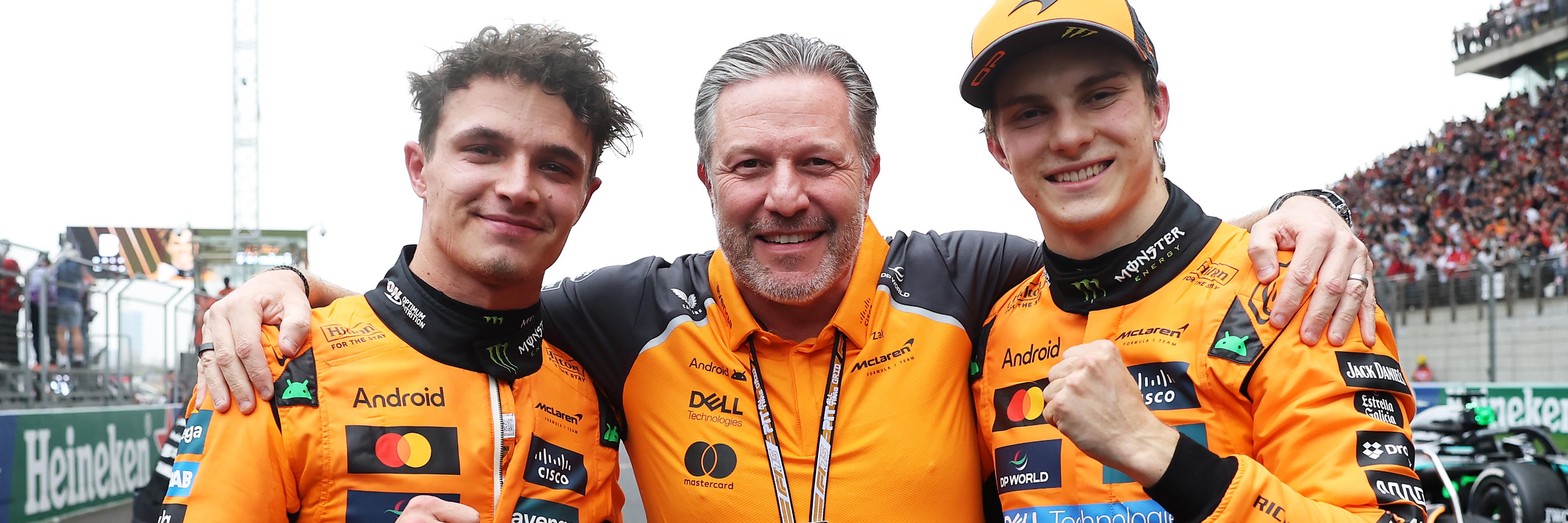 Lando Norris, Zak Brown and Oscar Piastri celebrate McLaren's 50th F1 1-2 finish