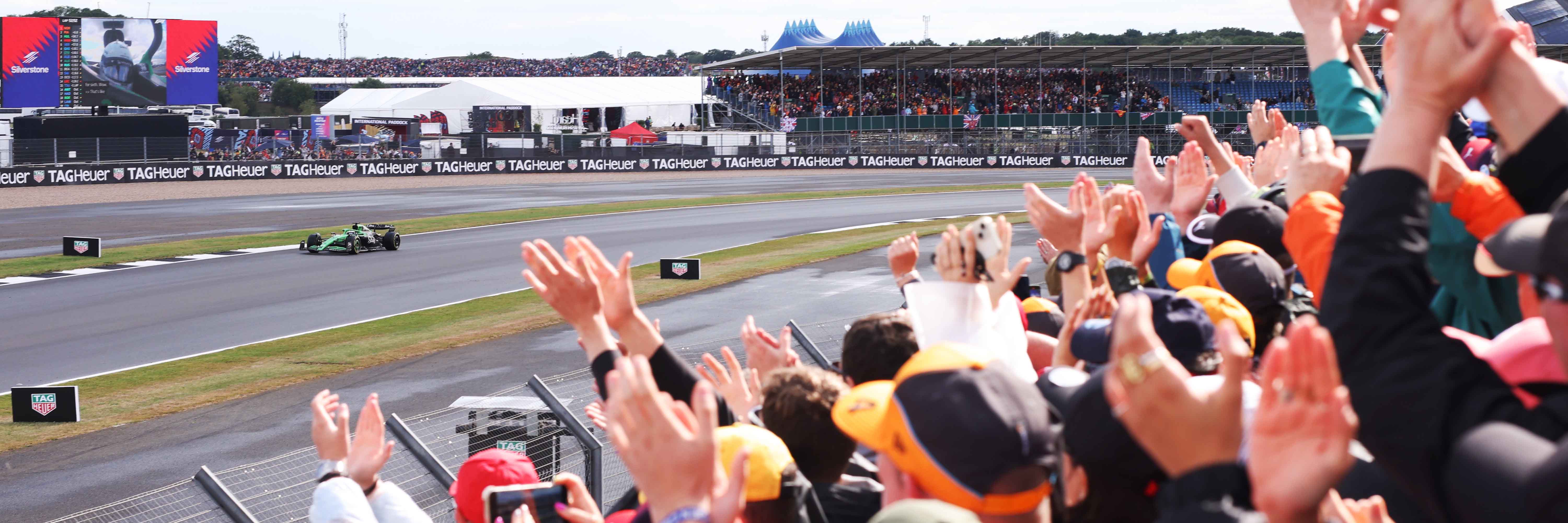 Nico Hulkenberg driving past the Abbey grandstand at Silverstone