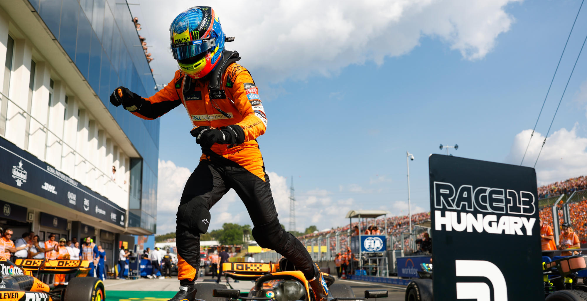 Oscar piastri jumps down from his car in parc ferme