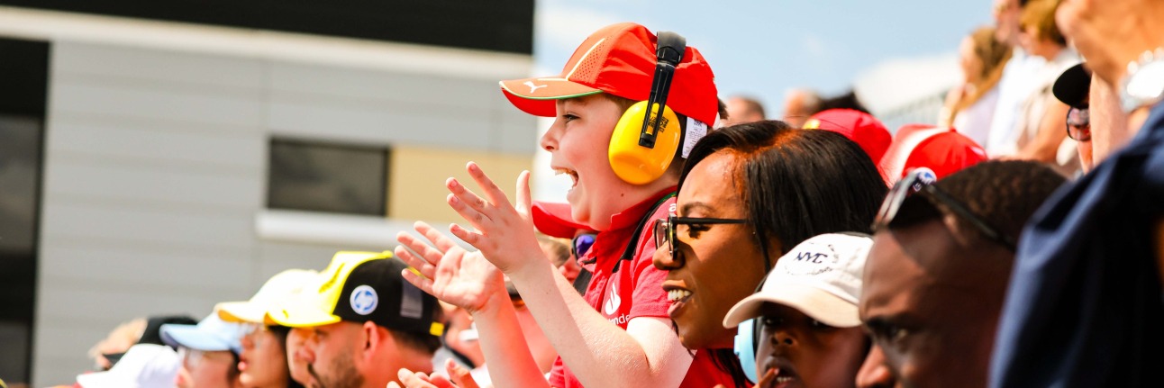 A young Formula 1 fan cheering at the British Grand Prix