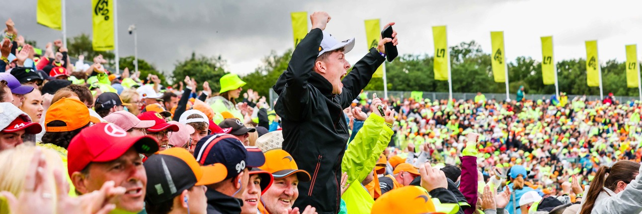 A Lando Norris fan celebrates as he watches F1 at Silverstone