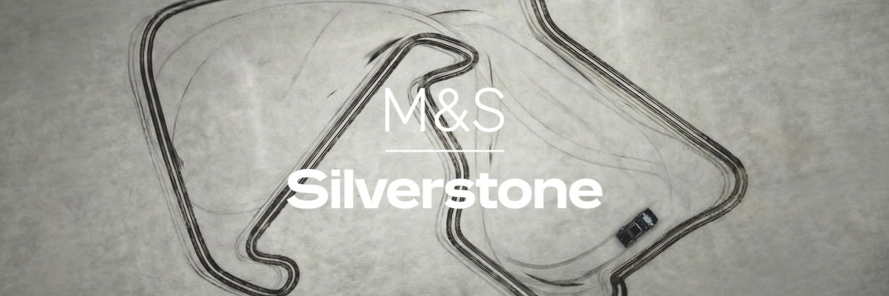 A car leaves tyre marks around the silverstone track outline. M&S and Silverstone Logo Lock-up Centre