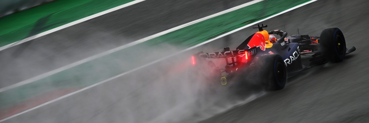 A Red Bull F1 car on track in rainy conditions in 2026 pre-season testing