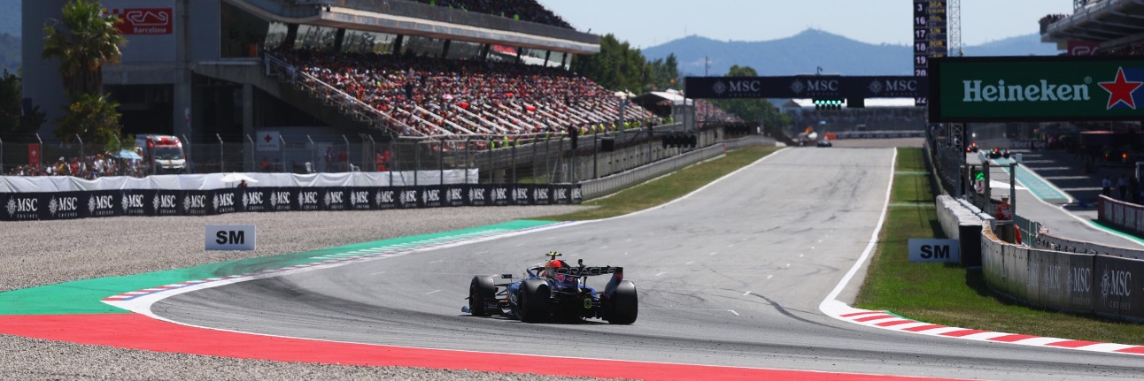 A Red Bull F1 car coming around the final corner at the Spanish Grand Prix