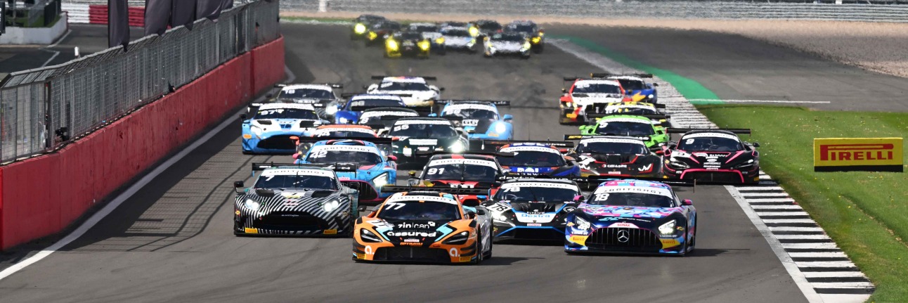 British GT cars racing to Turn 1 at Silverstone