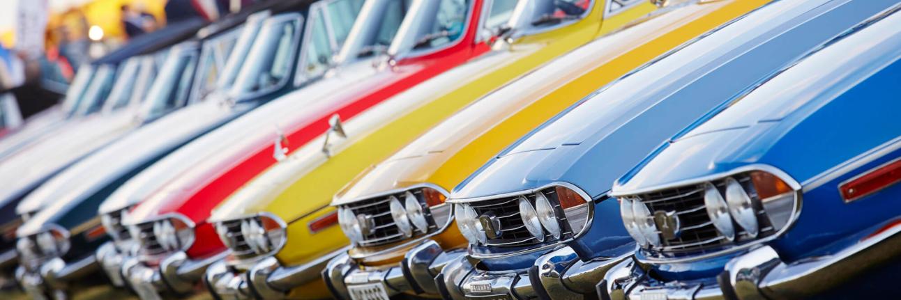 A line-up of colourful Triumph Stags at The Classic at Silverstone