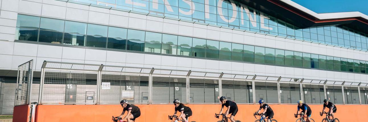 bicycles riding past the Silverstone Wing building