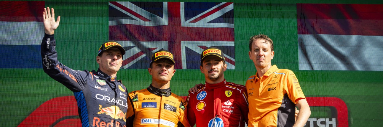 podium at zandvoort. verstappen waving, norris and leclerc middle, norris's engineer on the right