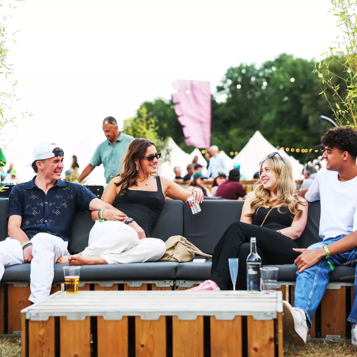 four people sitting down having drinks