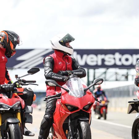 Riders conversing at Silverstone