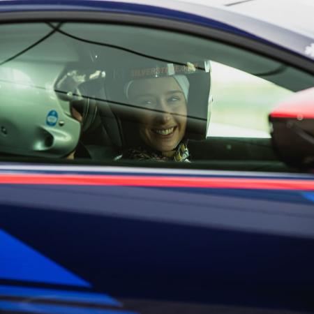 Lady smiles at instructor in car