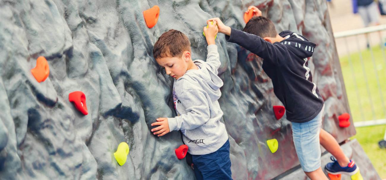 Children on climbing wall at BGP sport zone