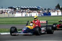 Nigel Mansell gives Ayrton Senna a lift on his Williams after the 1991 British Grand Prix at Silverstone