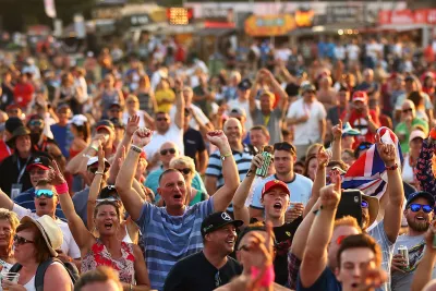 F1 fans with their arms up in the air